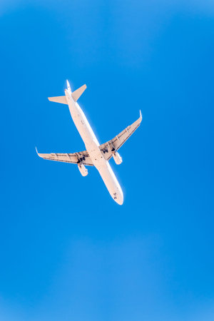 Airplane before landing in blue sky, Airbus A321-200. Air Transport. Tourism and travel concept.