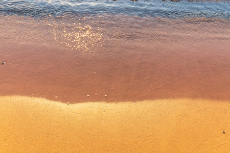 Soft wave of the sea on the sandy beach. Sea wave and gold sand.の写真素材