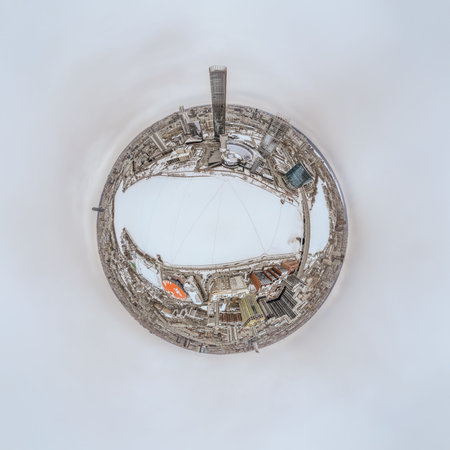 Aerial winter city view with crossroads and roads, houses, buildings, parks and bridges. Copter...