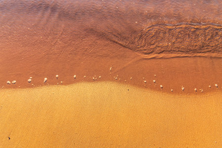Soft wave of the sea on the sandy beach. Sea wave and gold sand.の写真素材