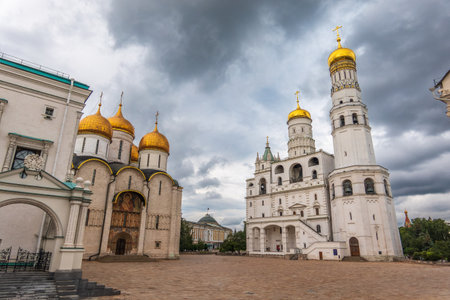 Ivan the Great Bell Tower, with Assumption Belfry on the right on a sunny day with blue sky. Blue sky background with sunbeams. Moscow Kremlin, Russiaの写真素材