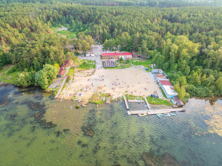 Summer holiday at the green lake. Rest on the beach, leisure time. Aerial view of small hidden beach surrounded by greenery. Aerial drone view of summer lake beachの写真素材