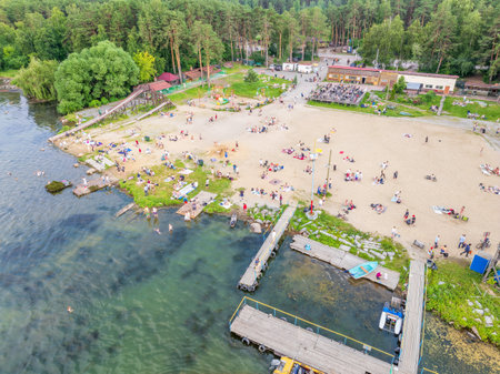 Summer holiday at the green lake. Rest on the beach, leisure time. Aerial view of small hidden beach surrounded by greenery. Aerial drone view of summer lake beachの写真素材
