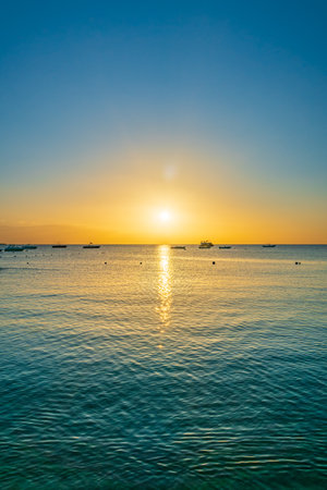 Sunrise over the sea. Panoramic seascape. Burning sky and shining golden waves. Sun over seaの写真素材