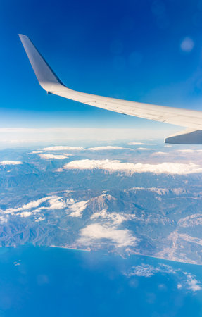 View from the airplane window of the mountains and sea resort with corals in Egypt. Flight. View from the airplane to sea and desert mountainsの写真素材