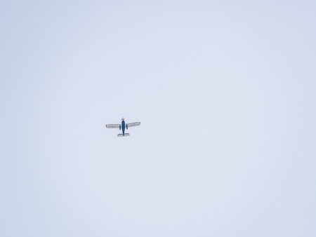 Small ultralight airplane with overhead wing and single propeller flying in sunset sky. Such aircraft are used for recreational, sport and flight training.の写真素材