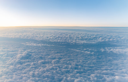 Beautiful sunrise over the clouds. View of the dawn in the clouds from the plane.の写真素材