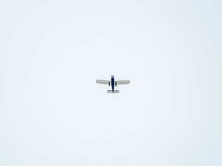 Small ultralight airplane with overhead wing and single propeller flying in sunset sky. Such aircraft are used for recreational, sport and flight training.の写真素材