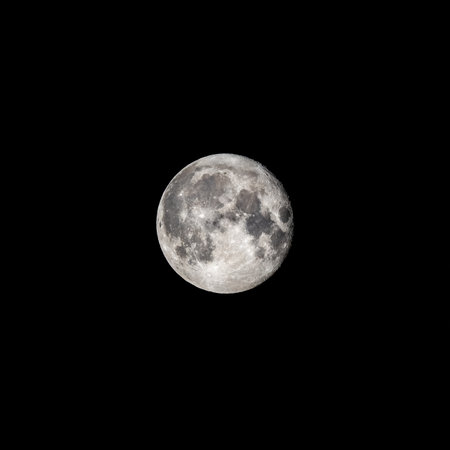 Detailed image of the full moon. Full moon against the black night sky. Full moon background isolated on blackの写真素材