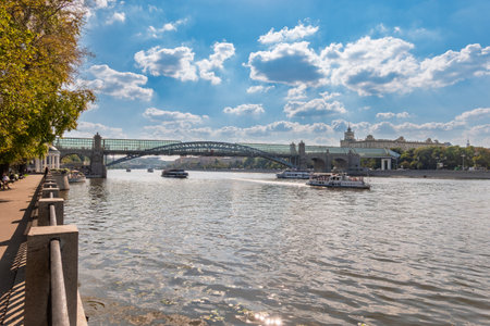 View of the Moscow river embankment, Pushkinsky bridge and cruise ships at sunset. Wide Moskva River, Pushkinsky bridge, Groky Park, Frunzenskaya embankment,の写真素材