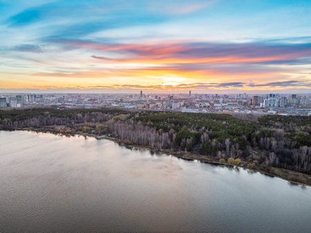 Colorful autumn forest with trees on the shore of a blue lake - top aerial view. Bright landscape autumn background with a bird's eye view. Copy Space template.の写真素材