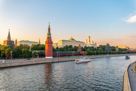 View of Kremlin with Vodovzvodnaya tower, Grand Kremlin Palace from Bolshoy Kamenny Bridge in Moscow on sunny summer day. View of Cruise ship on Moscow river from Greater Stone Bridge, Moscow, Russiaの写真素材