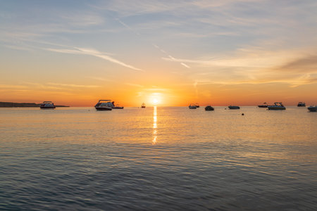 Sunrise over the sea. Panoramic seascape. Burning sky and shining golden waves. Sun over seaの写真素材