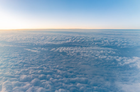 Beautiful sunrise over the clouds. View of the dawn in the clouds from the plane.の写真素材