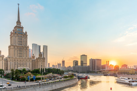 High-rise stalinist building near river at summer sunset in Moscow, Russia. Historic name is Hotel Ukraine. Spring or summer urban cityscape.の写真素材