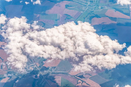 Aerial view from airplane window above green ground. View from the airplane window with beautiful...