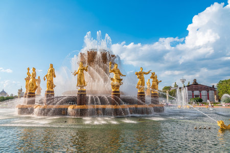 Moscow, Russia - August 4, 2023: The Peoples Friendship Fountain in VDNKh park in Moscow. Amazing sunny view of the Soviet architecture, landmark of Moscow. Beautiful luxurious old fountain in summer. Famous touristic placeのeditorial素材