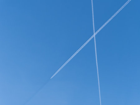 Blue sky with airplane trails and clouds. Blue sky with many clouds lines made of aircraftの写真素材