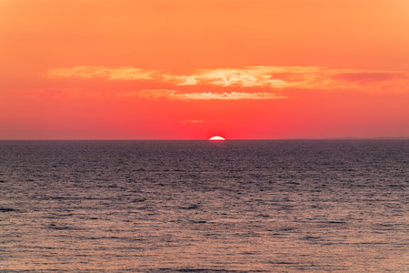 Red and orange sunrise over the sea. Seascape scenery, Amazing light of nature sunset backgroundの写真素材