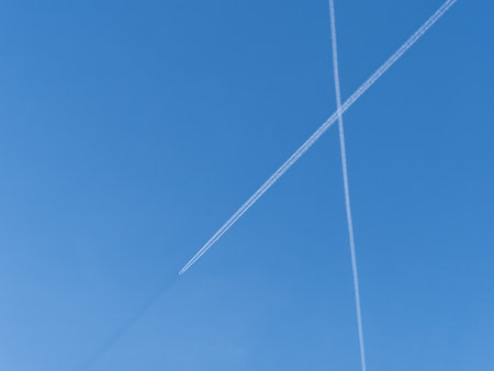 Blue sky with airplane trails and clouds. Blue sky with many clouds lines made of aircraftの写真素材