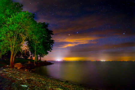 Lights In The Distance Over Lake Mille Lacs On A Slightly Cloudy Night Right After Sunsetの写真素材