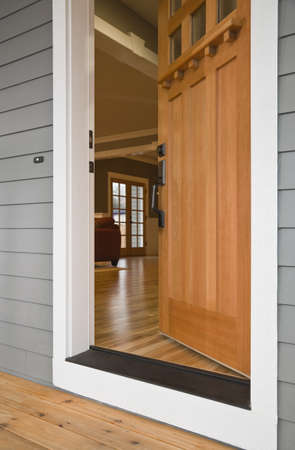 Exterior view of the open front door to a residence with the interior viewable from the outside. Vertical shot.の写真素材