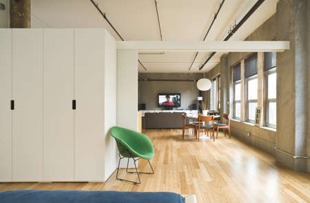 Modern style bedroom interior with an opened room divider showing the rest of the loft. Horizontal shot.の写真素材