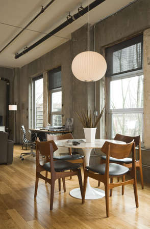 Dining room table and desk in a modern loft setting. Vertical shot.の写真素材
