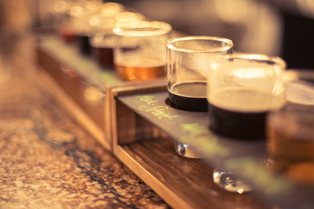 beer flights sitting on granite bar top with selective focus macroの写真素材