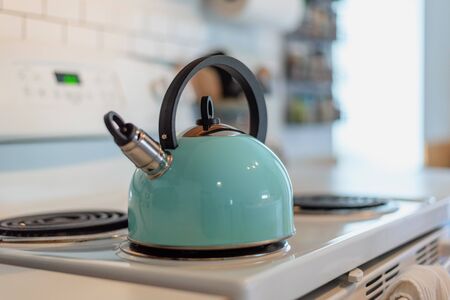 closeup of a modern tea pot on stove topの写真素材