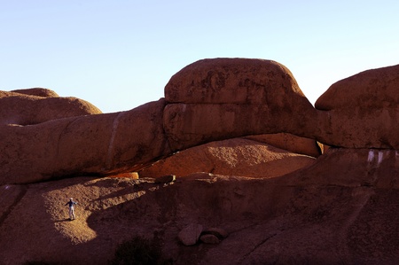 Sunrise at the natural arch at Spitzkoppe, Namibiaの写真素材