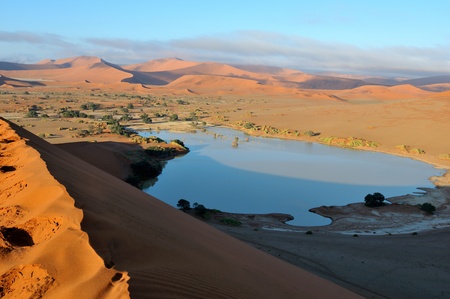 A rare sight: Sossusvlei in the Namib desert of Namibia filled with water. Some of the highest dunes in the world are in the background.の写真素材