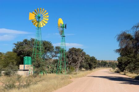 Twin windpumps in Namibia near Mata Mata on the South African borderの写真素材