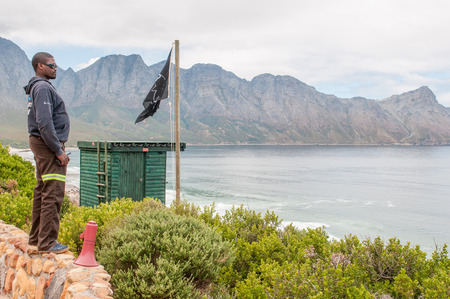 KOGELBERG, SOUTH AFRICA - DECEMBER 23, 2014: Shark spotter watching for sharks during a surfing competition. The black flag indicates poor shark spotting conditionsのeditorial素材