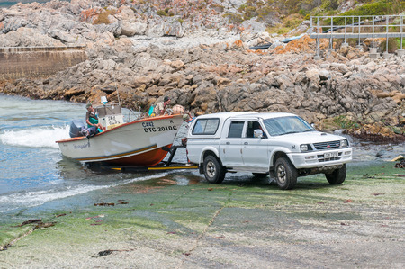 KLEINMOND, SOUTH AFRICA - DECEMBER 23, 2014: Crayfish boat being pulled onto a trailer with the days catch at Kleinmond harborのeditorial素材