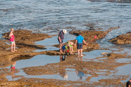 MOSSELBAY, SOUTH AFRICA - JANUARY 1, 2015: Unidentified people late afternoon at the Reebok beachのeditorial素材