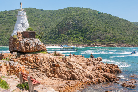 KNYSNA, SOUTH AFRICA - JANUARY 5, 2015: Sightseeing boats with tourists on the Knysna lagoon. A beacon with warning lights is on the leftのeditorial素材