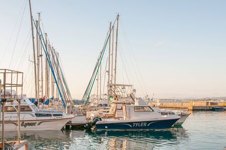 CAPE TOWN, SOUTH AFRICA - DECEMBER 11, 2014:  Boats at the harbor in Gordons Bay at sunsetのeditorial素材