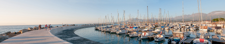 CAPE TOWN, SOUTH AFRICA - DECEMBER 11, 2014:  Sunset panorama of the harbor in Gordons Bay with buildings of Gordons Bay and The Strand in the backgroundのeditorial素材
