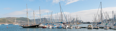 CAPE TOWN, SOUTH AFRICA - DECEMBER 12, 2014:  Simons Town harbor with two South African Navy Valour class frigates and S99, the SAS Assegaai, a Daphne class submarine, now a museum item, in the backのeditorial素材