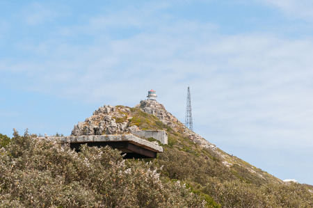 CAPE TOWN, SOUTH AFRICA - DECEMBER 12, 2014:  View from Dias Point at Cape Point towards the historic first lighthouse with a derelict military observation post from World War II in frontのeditorial素材