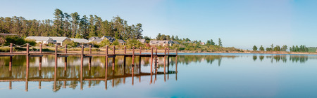 CAPE TOWN, SOUTH AFRICA - DECEMBER 18, 2014: Early morning panorama of houses next to a dam with jetty on the Wedderville Estate near Sir Lowrys Passのeditorial素材