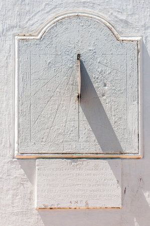 STELLENBOSCH, SOUTH AFRICA - DECEMBER 18, 2014: Sundial with inscription on the wall of the St. Mary...