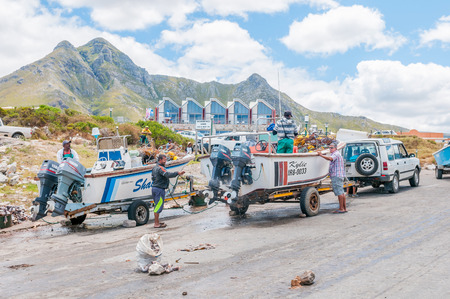 KLEINMOND SOUTH AFRICA  DECEMBER 23 2014: Unidentified fishermen cleaning Crayfish boats at the harborのeditorial素材