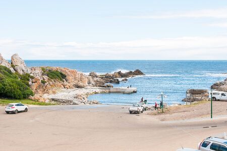 KLEINMOND SOUTH AFRICA  DECEMBER 23 2014: Washing a fishing boat at Kleinmond harborのeditorial素材