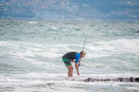 MOSSELBAY SOUTH AFRICA  DECEMBER 29 2014: Unidentified angler at a beach in Reebok near Mosselbay South Africaのeditorial素材