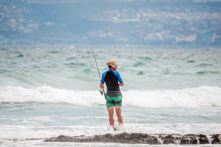 MOSSELBAY SOUTH AFRICA  DECEMBER 29 2014: Unidentified angler at a beach in Reebok near Mosselbay South Africaのeditorial素材