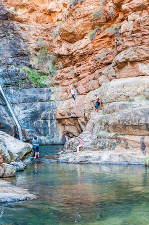 MEIRINGSPOORT SOUTH AFRICA  JANUARY 2 2015: An unidentified visitor jumping into the pool below the waterfallのeditorial素材