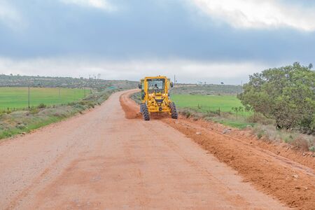 NUWERUS, SOUTH AFRICA - AUGUST 13, 2015: A road grader working on the road between Lutzville and Nuwerusのeditorial素材