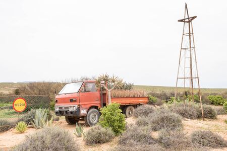 VANRHYNSDORP, SOUTH AFRICA - AUGUST 12, 2015: A display of a vehicle with aloes and quiver trees next to the road between Vanrhynsdorp and Vredenburg in the Western Cape Provinceのeditorial素材